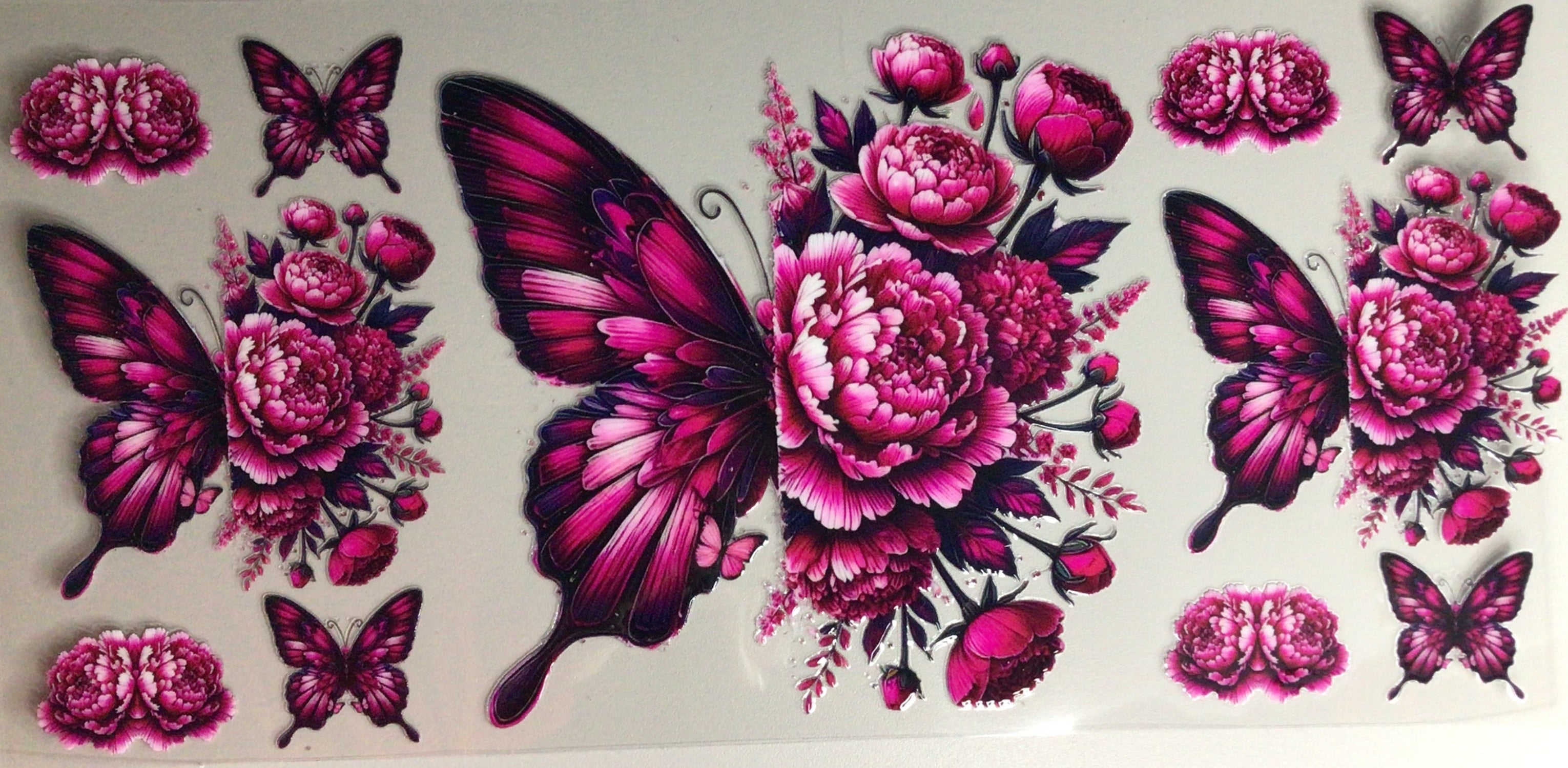 Sticker design with pink butterflies and flowers on a white background