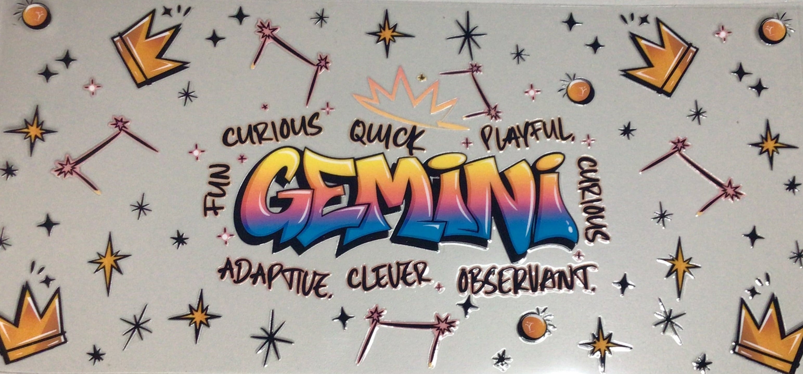 Decorative wall art with colorful text and graphics on a light gray background