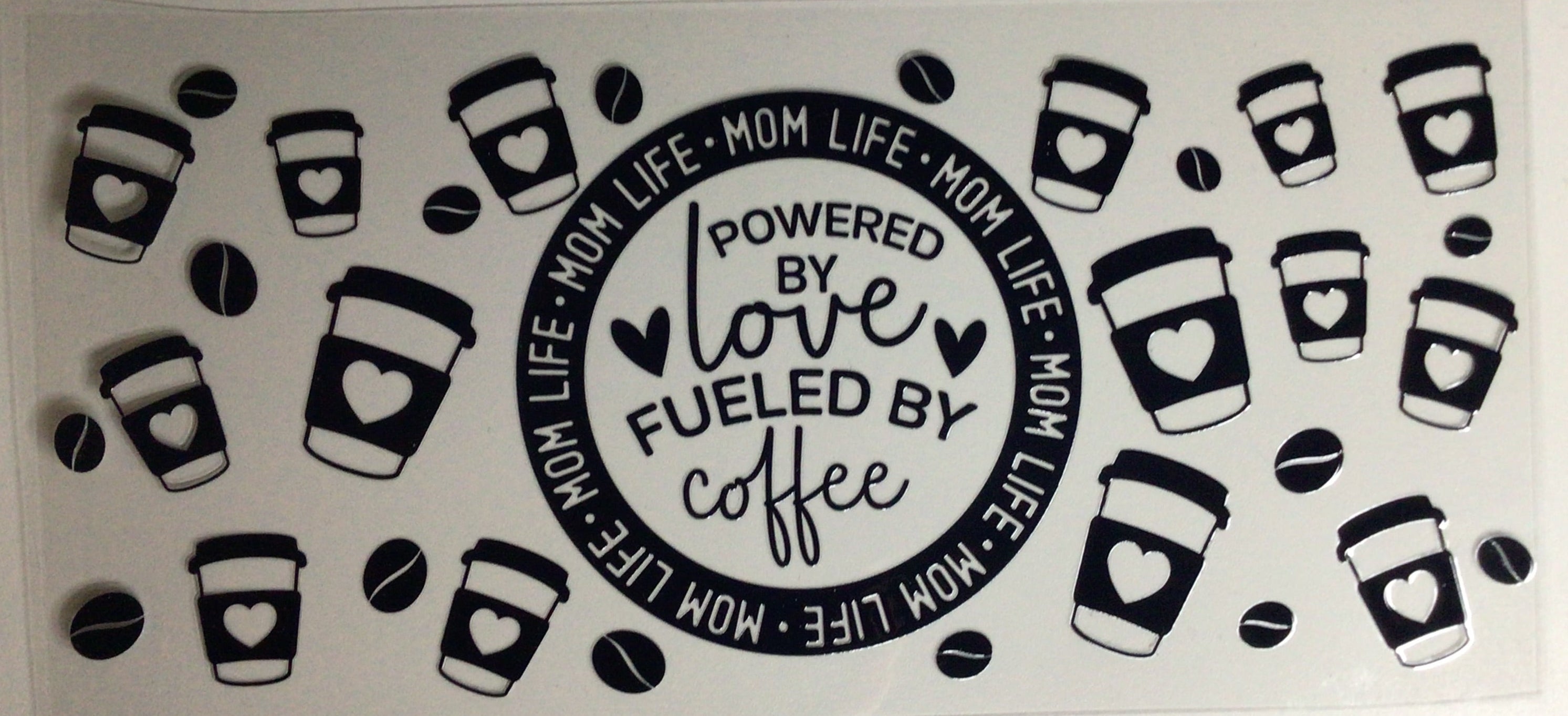 Decorative mat with coffee cup designs and text on a plain background