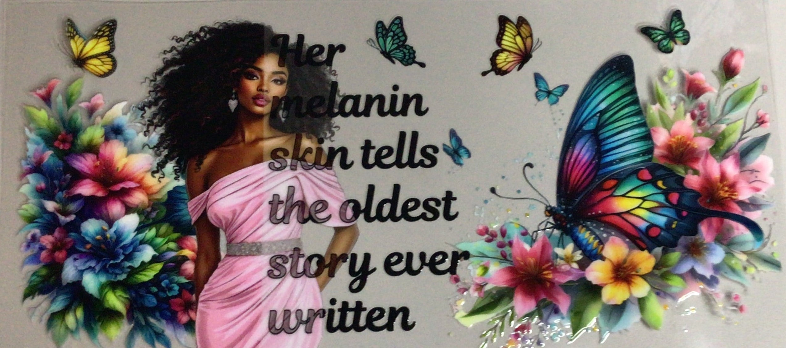 Decorative wall art with colorful flowers, butterflies, and a quote on a plain background